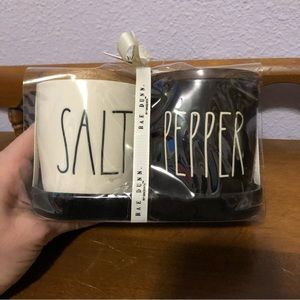 Rae Dunn salt and pepper holders with woofer lid and ceramic tray to hold them.